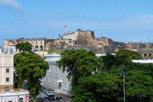 a view of a city with a castle in the background at Hotel Rumbao, a Tribute Portfolio Hotel in San Juan