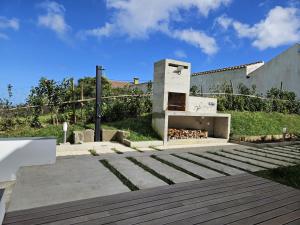 a building with a fireplace in a yard at Casa do Cinzeiro, Açores - With private pool! in Nordeste