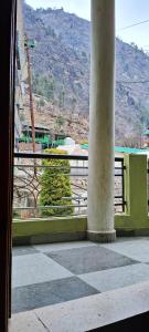 a view from a window of a building with a pillar at Little Hamlet Choj in Kasol