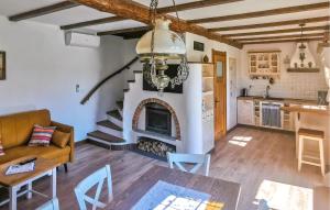 a living room with a fireplace and a kitchen at Cozy Home In Kopalino With Wifi in Kopalino