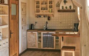 a kitchen with wooden cabinets and a wooden table at Cozy Home In Kopalino With Wifi in Kopalino