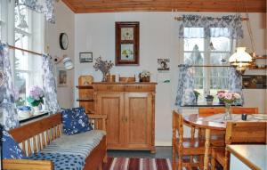 a living room with a table and a dining room at 2 Bedroom Awesome Home In Storfors in Storfors