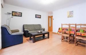 a living room with a couch and a table and a bed at Cozy Apartment In Torrevieja With Wifi in Torrevieja
