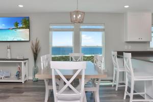 a dining room with a table and a view of the ocean at Pelican Roost A by Pristine Properties Vacation Rentals in Mexico Beach
