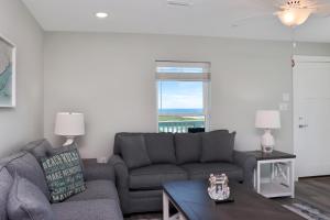 a living room with a couch and a table at Pelican Roost A by Pristine Properties Vacation Rentals in Mexico Beach