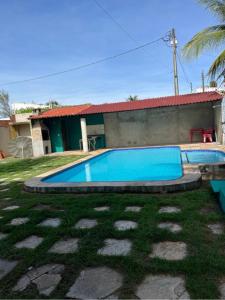 a swimming pool in front of a house at Casa de Praia na Tabuba-Ceará in Caucaia