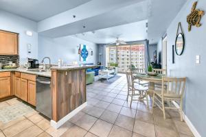 a kitchen and dining room with a table and chairs at Shores of Panama 1816 in Panama City Beach