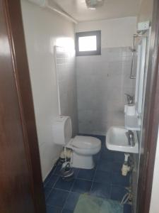 a bathroom with a toilet and a sink at Studio in Mbour
