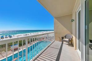 a balcony with a view of a pool and the beach at Seychelles 207 in Panama City Beach