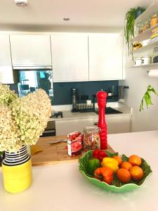 a bowl of fruits and vegetables on a counter in a kitchen at The Hoxton Nest - Shoreditch in London