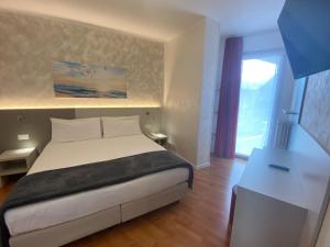 Ένα ή περισσότερα κρεβάτια σε δωμάτιο στο Hotel Angelini