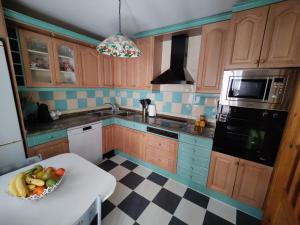 a kitchen with a bowl of fruit on a table at Casa Baire in Puigmoreno +15 photos