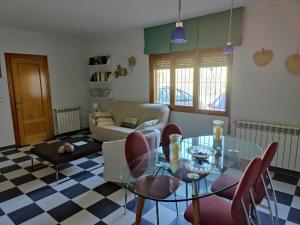 a living room with a glass table and chairs at Casa Baire in Puigmoreno