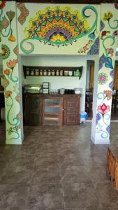 a kitchen with a counter with a colorful wall at Hostel e Pousada da 13 Olinda in Olinda