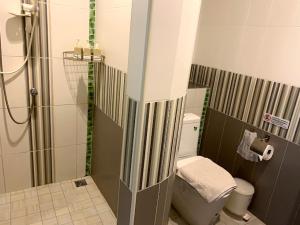 a small bathroom with a shower and a toilet at Wind Beach Resort in Koh Tao