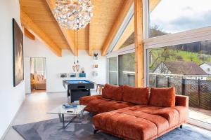 a living room with a couch and a pool table at ※Luxus Loft mit Boxspringbetten und Heimkino ※ in Inzlingen