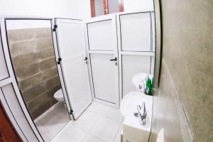 a bathroom with a shower and a toilet and a sink at MARHABA INN by HB Hostels in Tétouan