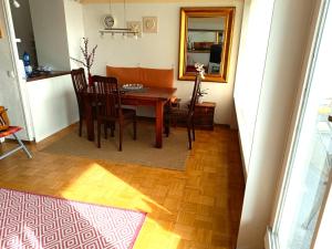 a dining room with a table and chairs and a mirror at Panoramic App A07-6 in Sierksdorf