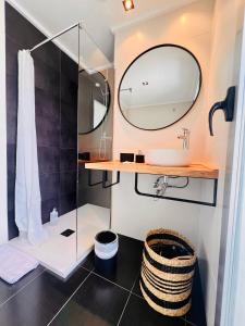 a bathroom with a sink and a mirror at Àtico Espuma - Marenia´s Dream in Denia