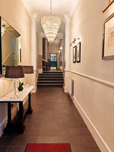 a hallway with a long hall with stairs and a lamp at Frederick House Hotel in Edinburgh