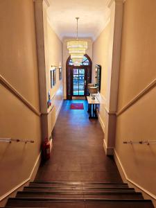 a hallway of a building with stairs and a chandelier at Frederick House Hotel in Edinburgh