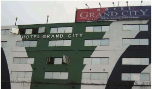 a building with a hotel grand city sign on it at Hotel YSM Grand in Tezpur