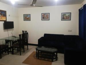 a living room with a couch and a table at Two Bedrooms Apartment Near DHA & Airport in Lahore