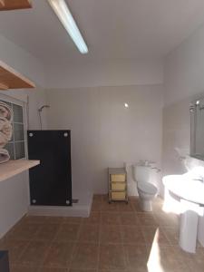 a bathroom with a toilet and a sink at Bonita Casita Luz del Sol in Arboleas +23 photos