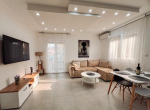 a living room with a couch and a table at M&N Residence Tivat in Tivat