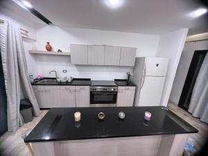 a kitchen with a black counter top and a stove at Giving Paradise Chalet in Amman