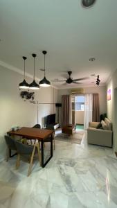 a living room with a table and a couch at Embassy Home KLCC Jalan Ampang in Kuala Lumpur