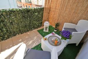 a patio with a table and chairs on a balcony at CasApulia - Bari Airport apartment in Bitonto