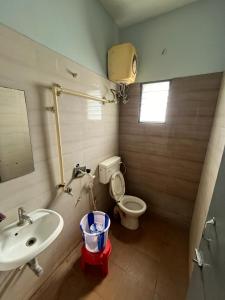 a bathroom with a sink and a toilet at THE ALP HOTEL in Madurai