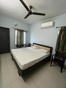 a bedroom with a bed and a ceiling fan at THE ALP HOTEL in Madurai