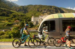a group of people on bikes next to a bus at Pension Panorama in San Lorenzo di Sebato