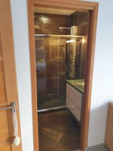 a glass door to a kitchen with a sink at Belle villa, piscine et cigales au calme ! in Saint-Jean-de-Védas