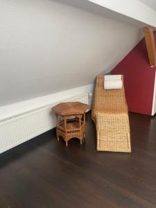 a room with a table and a chair and a stool at Schöne Aussicht in Geiselbach