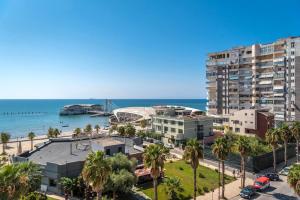 a view of the beach and buildings and the ocean at Three Bedroom Romantic Promenade Apartment in Durrës