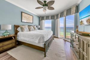 a bedroom with a bed and a large window at Grandview East 702 in Panama City Beach +34 photos