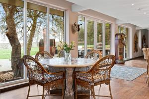 a dining room with a table and chairs at Normanton Park House - Luxury Rutland Water Home in Oakham