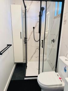 a bathroom with a shower and a toilet at Stylish tiny home in Melton west in Melton