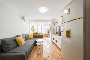salon z szarą kanapą i kuchnią w obiekcie Casita del Puerto 1 w mieście Santa Pola +16 zdjęć