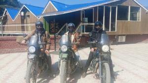 three people on motorcycles parked in front of a building at Da Shack in Mandi