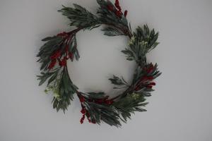 a christmas wreath with green leaves and red berries at LP - 4 saisons in Annecy