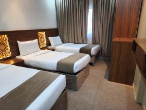 Een bed of bedden in een kamer bij فندق الششة