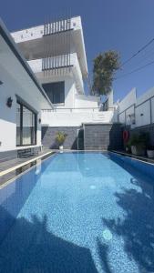 a large swimming pool in front of a house at NS Villa in Pokhara