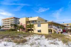 a building on the beach next to the beach at 239 Surf Song Resort in St. Pete Beach