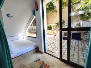 a room with a door open to a patio at Naupactus unique harbor apartment in a stone house! in Nafpaktos
