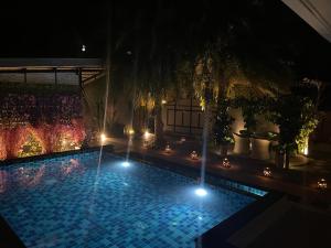 a swimming pool at night with lights on it at 3 Bedroom Platinum Pool Villa Smooth as Silk in Ban Khlong Haeng