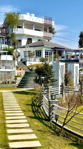 a building with stairs in front of a yard at NS Villa in Pokhara